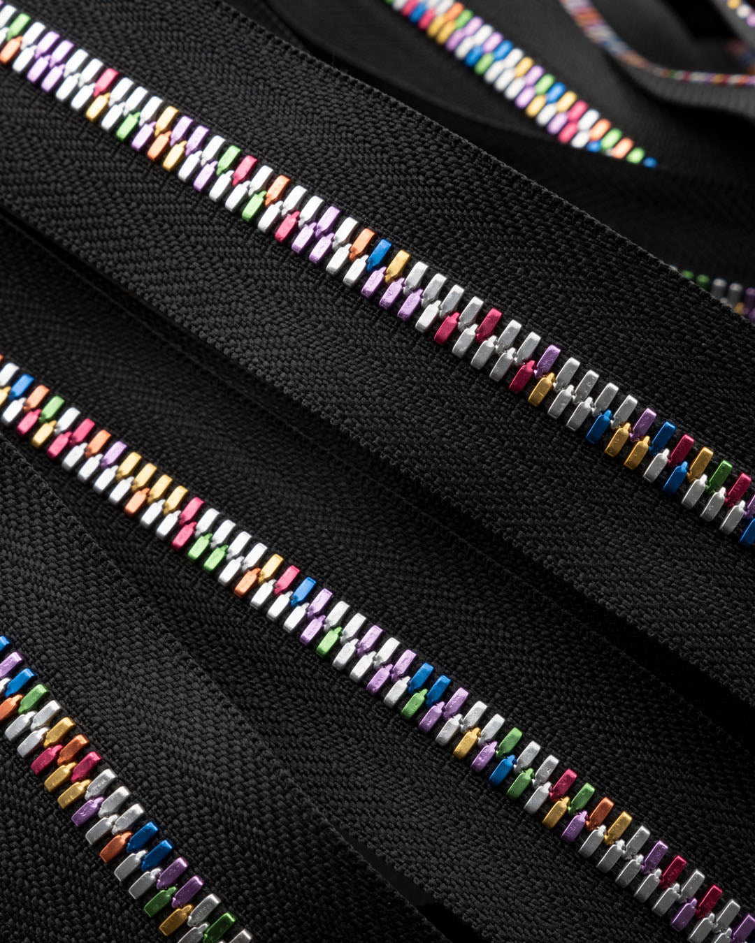 Excella® Light | Rainbow colored YKK zipper on a roll