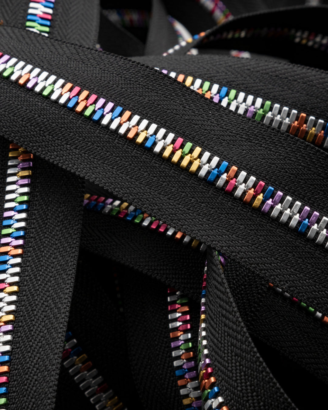 Excella® Light | Rainbow colored YKK zipper on a roll